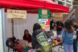 Students visiting a stall serving food inspired by Yasi’s poems